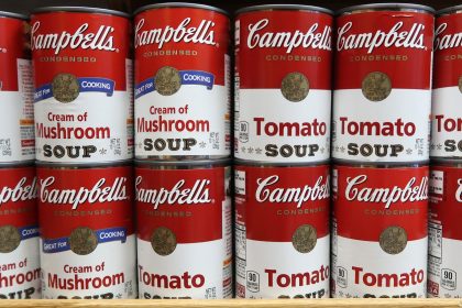 cans of campbells soup sit on a shelf in a grocery store on news photo 1046599136 1542810801
